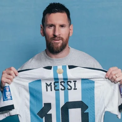 This undated photo provided by Sotheby's courtesy of Sam Robles photography shows Lionel Messi holding one of six match worn shirts from the 2022 FIFA World Cup. A set of six shirts worn by Lionel Messi during Argentina's victorious run to the 2022 World Cup in Qatar will be auctioned off in December, Sotheby's announced November 20, estimating their value at over $10 million. (Photo by Sam ROBLES / Sam Robles photography / AFP) / RESTRICTED TO EDITORIAL USE - MANDATORY CREDIT "AFP PHOTO / HANDOUT / SAM ROBLES PHOTOGRAPHY / SOTHEBY'S" - NO MARKETING - NO ADVERTISING CAMPAIGNS - DISTRIBUTED AS A SERVICE TO CLIENTS<!-- NICAID(15603395) -->