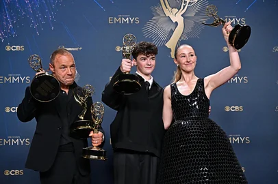 (L-R) British actor Stephen Graham poses in the press room with the awards for Outstanding Limited or Anthology Series, Outstanding Lead Actor in a Limited or Anthology Series or Movie, Outstanding Writing for a Limited Series or Anthology Series or Movie for "Adolescence", British actor Owen Cooper poses in the press room with the award for Outstanding Supporting Actor in a Limited or Anthology Series or Movie for "Adolescence" and British actress Erin Doherty poses in the press room with the award for Outstanding Supporting Actress in a Limited or Anthology Series or Movie award for "Adolescence" during the 77th Primetime Emmy Awards at the Peacock Theatre at LA Live in Los Angeles on September 14, 2025. (Photo by Frederic J. Brown / AFP) / RESTRICTED TO EDITORIAL USE<!-- NICAID(16124198) -->
