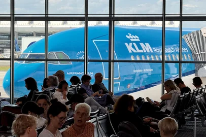 A KLM plane is seen through the window as engers wait to board at Washington Dulles International Airport (IAD) in Dulles, Virginia on May 2, 2025. (Photo by Daniel SLIM / AFP)<!-- NICAID(16029444) -->
