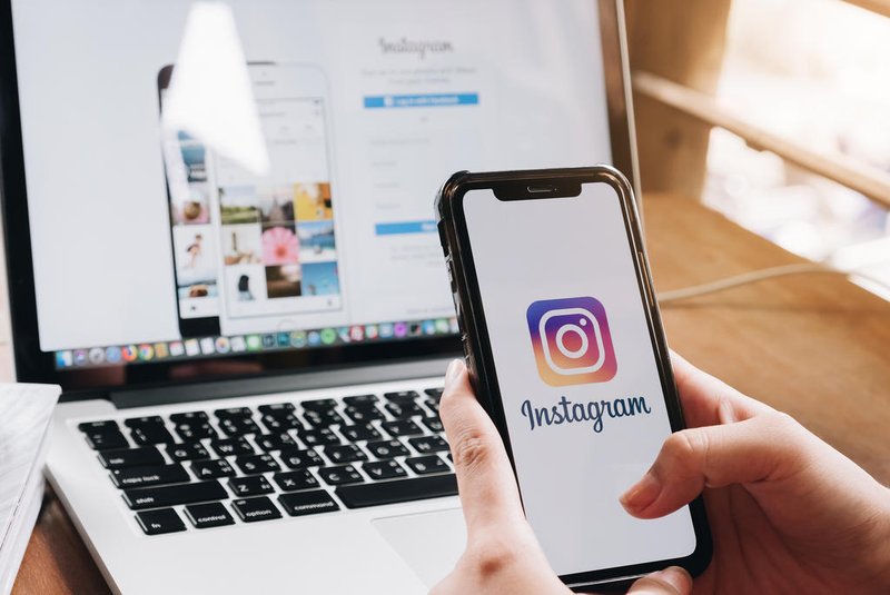 CHIANG MAI, THAILAND - AUG 26, 2018: A woman holds Apple iPhone X with Instagram application on the screen at cafe. Instagram is a photo-sharing app for smartphones.<!-- NICAID(15592786) -->