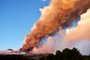 This photo obtained from Italian news agency ANSA shows the Etna volcano in Catania, Sicily, on February 16, 2021 during a spectacular eruption and a strong explosive activity from the south-east crater and the emission of a high cloud of lava ash that disperses towards the south. (Photo by Handout / ANSA / AFP) / Italy OUT<!-- NICAID(14717186) -->