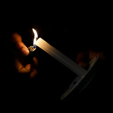 Porto Alegre, RS, Brasil, 19-10-2021: Mulher abrigada acende uma vela na Casa de Mulheres Mirabal, que abriga mulheres e criancas em situacao de risco na zona norte.  A ocupacao esta sem energia eletrica desde o inicio de setembro, por causa de corte da CEEE devido a pagamentos atrasados da epoca em que uma escola estadual funcionava naquele espaco. (Foto: Mateus Bruxel / Agencia RBS)Indexador: Mateus Bruxel<!-- NICAID(14919048) -->