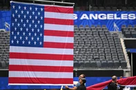 Workers install a US flag above the pitch inside Los Angeles Stadium (temporarily renamed from SoFi Stadium) ahead of the 2026 FIFA World Cup in Los Angeles on June 7, 2026. (Photo by Patrick T. Fallon / AFP)<!-- NICAID(16304885) -->