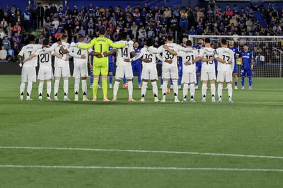 Players stand for a minute of silence in honour of the late Pope Francis during the Spanish league football match between Getafe CF and Real Madrid CF at the Coliseum Alfonso Perez stadium in Getafe, on April 23, 2025. (Photo by Thomas COEX / AFP)<!-- NICAID(16022835) -->