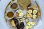 Large selection of breakfast food on a table with quail eggs, cookies,  toasts, chocolate, banana, yogurt, chocolate butter, nuts served with coffee viewed from above - Foto: Zkolra/stock.adobe.comFonte: 270773208<!-- NICAID(15288303) -->