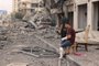 Palestinian men look at the destruction outside a damaged apartment building following Israeli airstrikes on Gaza City on October 10, 2023. Israel kept up its deadly bombardment of Hamas-controlled Gaza on October 10 after the Palestinian militant group threatened to execute some of the around 150 hostages it abducted in a weekend assault if air strikes continue without warning. (Photo by MAHMUD HAMS / AFP)Editoria: WARLocal: Gaza CityIndexador: MAHMUD HAMSSecao: armed conflictFonte: AFPFotógrafo: STF<!-- NICAID(15565017) -->