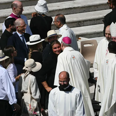 Mother of late Carlo Acutis, Antonia Salzano (C) is greeted by a member of the clergy after a Holy Mass and canonisation of Blessed Carlo Acutis and Pier Giorgio Frassati in St Peter's Square at the Vatican on September 7, 2025. An Italian teenager dubbed "God's Influencer" for his efforts to spread the Catholic faith online will become the first millennial saint Sunday at a canonisation attended by thousands of pilgrims. Computer whiz Carlo Acutis, who died of leukemia in 2006 aged 15, will be raised to sainthood by Pope Leo XIV in a solemn ceremony in St Peter's Square at the Vatican. Italian Pier Giorgio Frassati, a mountaineering enthusiast who died in 1925 and was known for his social and spiritual commitment, will also be made a saint on September 7, 2025. (Photo by Filippo MONTEFORTE / AFP)<!-- NICAID(16121814) -->