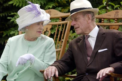 (FILES) In this file photo taken on July 17, 2002 Britain's Queen Elizabeth II (L) and Britain's Prince Philip, Duke of Edinburgh (R) chat while seated during a musical performance in the Abbey Gardens, Bury St Edmunds, during her Golden Jubilee visit to Suffolk, east of England. - Queen Elizabeth II's 99-year-old husband Prince Philip, who was recently hospitalised and underwent a successful heart procedure, died on April 9, 2021, Buckingham Palace announced. (Photo by Fiona HANSON / POOL / AFP)<!-- NICAID(14753903) -->