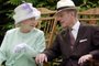 (FILES) In this file photo taken on July 17, 2002 Britain's Queen Elizabeth II (L) and Britain's Prince Philip, Duke of Edinburgh (R) chat while seated during a musical performance in the Abbey Gardens, Bury St Edmunds, during her Golden Jubilee visit to Suffolk, east of England. - Queen Elizabeth II's 99-year-old husband Prince Philip, who was recently hospitalised and underwent a successful heart procedure, died on April 9, 2021, Buckingham Palace announced. (Photo by Fiona HANSON / POOL / AFP)<!-- NICAID(14753903) -->
