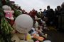People lay flowers and dolls at a makeshift memorial in front of the Crocus City Hall in Krasnogorsk on March 24, 2024, as Russia observes a national day of mourning after a massacre that killed more than 130 people. (Photo by Olga MALTSEVA / AFP)<!-- NICAID(15714528) -->