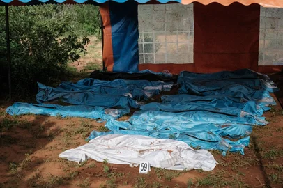 Exhumed bodies in bodybags are displayed on the ground prior to a transport to the mortuary, at the mass-grave site in Shakahola, outside the coastal town of Malindi, on April 25, 2023. - Kenyan investigators unearthed another 16 bodies on Tuesday in a forest where a cult was believed to be practising mass starvation, bringing the number of victims so far to 89 including children. There are fears more corpses could be found in Shakahola forest where cult leader Paul Mackenzie Nthenge had allegedly been telling his followers that starvation was the only path to God. (Photo by Yasuyoshi CHIBA / AFP)<!-- NICAID(15411960) -->