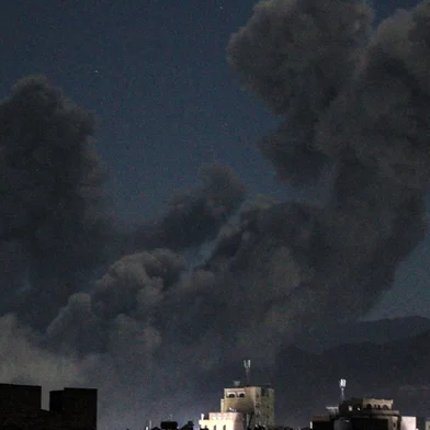 A plume of smoke billows during a US strike on Yemen's Huthi-held capital Sanaa early on March 16, 2025. The first US strikes against Yemen's Huthis since President Donald Trump took office in January killed at least 31 people, the rebels said on March 16, as Washington warned Iran to stop backing the group. (Photo by Mohammed HUWAIS / AFP)<!-- NICAID(15996498) -->