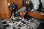 Planalto Presidential Palace security members inspect offices destroyed by supporters of Brazilian former President Jair Bolsonaro after an invasion in Brasilia on January 9, 2023. - Brazilian security forces locked down the area around Congress, the presidential palace and the Supreme Court Monday, a day after supporters of ex-president Jair Bolsonaro stormed the seat of power in riots that triggered an international outcry.In stunning scenes reminiscent of the January 6, 2021 invasion of the US Capitol building by supporters of then-president Donald Trump, backers of Bolsonaro broke through police cordons and overran the seats of power in Brasilia, smashing windows and doors and ransacking offices. (Photo by CARL DE SOUZA / AFP)Editoria: WARLocal: BrasíliaIndexador: CARL DE SOUZASecao: demonstrationFonte: AFPFotógrafo: STF<!-- NICAID(15315838) -->