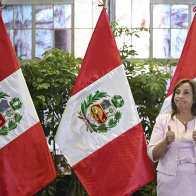 (FILES) Peru's President Dina Boluarte gestures during a ceremony enacting an amnesty law for military and police personnel prosecuted for human rights violations at the Government Palace in Lima on August 13, 2025. Lawmakers in Peru unanimously voted on October 10, 2025, to impeach president Dina Boluarte, whose term has been marked by protests and accusations of failing to stem crime. (Photo by Ernesto BENAVIDES / AFP)<!-- NICAID(16143740) -->