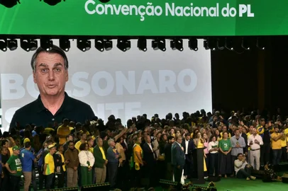 An AI generated video of former president Jair Bolsonaro -who was banned from taking part as he is serving house arrest- is screened during the launching of the presidential candidacy of his son, right-wing presidential hopeful Flavio Bolsonaro within the Liberal Party (PL) convention, in Sao Paulo, Brazil on July 25, 2026. Battered by a string of political crises, Flavio Bolsonaro launched his candidacy for Brazil's October presidential election, seeking to follow in the footsteps of his father, Jair Bolsonaro, who is serving house arrest for plotting a coup after losing the election in 2022. (Photo by Nelson ALMEIDA / AFP)<!-- NICAID(16336469) -->