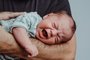 newborn on his father's arm screams crying with expression of sufferingnewborn on his father's arm screams crying with expression of sufferingIndexador: EVA HMFonte: 490286829<!-- NICAID(15473501) -->