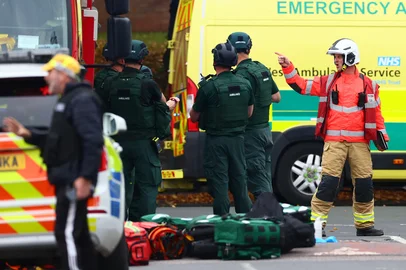 Members of the Fire and Ambulance service are pictured inside a Police cordon near Heaton Park Hebrew Congregation synagogue in Crumpsall, north Manchester, on October 2, 2025, following an incident at the synagogue. Four people were wounded Thursday in a car and stabbing incident outside a synagogue in northern Manchester, police said, adding the suspect had been shot. Police were alerted to the incident at 9:31 am (0831 GMT) and paramedics were treating "four members of the public with injuries caused by both the vehicle and stab wounds," the police said on X. (Photo by Paul Currie / AFP)<!-- NICAID(16137565) -->