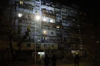 Rescuers stand in front of a damaged residential building following a drone attack in Kyiv on March 23, 2025, amid the Russian invasion of Ukraine. (Photo by Genya SAVILOV / AFP)<!-- NICAID(16001637) -->
