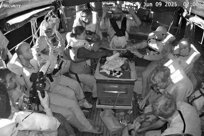 An image grab from footage released by Freedom Flotilla Coalition on June 9, 2025 shows activists on board the Gaza-bound aid boat Madleen, with their hands in the air, as they are being intercepted by the Israeli forces in international waters before reaching the blockaded Palestinian territory. The boat was redirected to Israel's shores, preventing the activists onboard, including Swedish campaigner Greta Thunberg and European parliament member Rima Hassan, from reaching the Gaza Strip. (Photo by Freedom Flotilla Coalition / AFP) / RESTRICTED TO EDITORIAL USE - MANDATORY CREDIT "AFP PHOTO / FREEDOM FLOTILLA COALITION " - NO MARKETING NO ADVERTISING CAMPAIGNS - DISTRIBUTED AS A SERVICE TO CLIENTS<!-- NICAID(16055343) -->