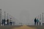 People walk along the Kartavya Path near India Gate amid heavy smog conditions in New Delhi on November 3, 2023. Schools were shut across India's capital on November 3 as a noxious grey smog engulfed the megacity and made life a misery for its 30 million inhabitants. (Photo by ARUN THAKUR / AFP)<!-- NICAID(15587294) -->