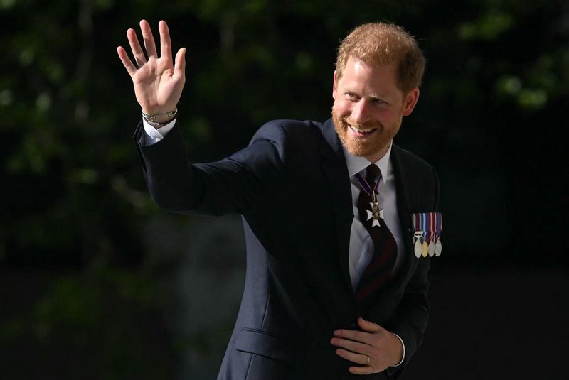 Britain's Prince Harry, Duke of Sussex waves as he arrives to attend a ceremony marking the 10th anniversary of the Invictus Games, at St Paul's Cathedral in central London, on May 8, 2024. (Photo by JUSTIN TALLIS / AFP)<!-- NICAID(15758620) -->