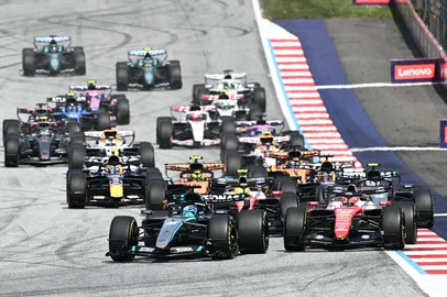 Mercedes' British driver George Russell, Ferrari's Monegasque driver Charles Leclerc and Ferrari's British driver Lewis Hamilton compete at the start of the Formula One Austrian Grand Prix at the Red Bull Ring race track in Spielberg, Austria on June 28, 2026. (Photo by Joe Klamar / AFP)<!-- NICAID(16317056) -->