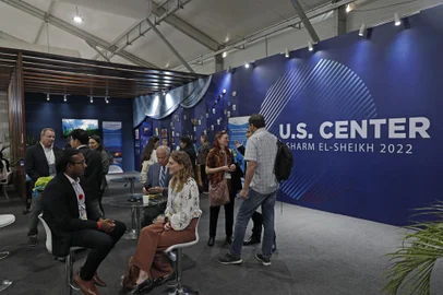 Attendees sit at the US Center at the Sharm el-Sheikh International Convention Centre, in Egypt's Red Sea resort city of the same name, during the COP27 climate conference, on November 10, 2022. (Photo by MOHAMMED ABED / AFP)<!-- NICAID(15261094) -->