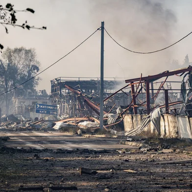 This photograph shows smoke rising from damaged buildings at the site of a Russian air attack in Kyiv region on August 29, 2026, amid the Russian invasion of Ukraine. Russia struck an arms depot near Kyiv overnight, sparking fires and explosions that killed 37 people and wounded dozens of others, authorities said. (Photo by Serhii Okunev / AFP)<!-- NICAID(16356513) -->