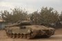An Israeli soldier sits atop a tank near the border with the Gaza Strip on November 12, 2023, amid the ongoing battles between Israel and the Palestinian group Hamas. (Photo by GIL COHEN-MAGEN / AFP)<!-- NICAID(15596591) -->