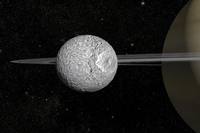 This handout image released on February 7, 2024 by Animea Studio - Observatoire de Paris - PSL, IMCCE - shows an artist's impression of the 400-km diameter Mimas, one of Saturns small moons. Astronomers compare it to the Death Star from Star Wars, but it turns out to be more hospitable than imagined: Mimas, a small moon of Saturn, contains an unlikely liquid ocean under its icy surface, ideal for the appearance of life, according to a study published on February 7, 2024. (Photo by Frederic Durillon / Animea Studio / Observatoire de Paris - PSL, IMCCE / AFP) / - NO Editorial use - NO Marketing campaign / -----EDITORS NOTE --- RESTRICTED TO EDITORIAL USE - MANDATORY CREDIT "AFP PHOTO /  HO / ANIMEA STUDIO - OBSERVATOIRE DE PARIS - PSL - IMCCE" - NO MARKETING - NO ADVERTISING CAMPAIGNS - DISTRIBUTED AS A SERVICE TO CLIENTS / Editoria: SCILocal: In the airIndexador: FREDERIC DURILLONSecao: space programmeFonte: Animea Studio _ Observatoire de Fotógrafo: Handout<!-- NICAID(15673154) -->