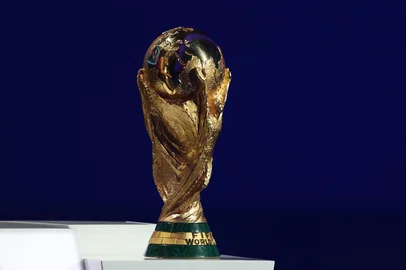 The FIFA World Cup trophy is seen on stage during the draw for the 2026 FIFA Football World Cup taking place in the US, Canada and Mexico, at the Kennedy Center, in Washington, DC, on December 5, 2025. (Photo by Dan Mullan / POOL / AFP)<!-- NICAID(16181195) -->
