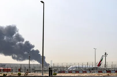 A smoke plume rises from an ongoing fire near Dubai International Airport in Dubai on March 16, 2026. Flights were gradually resuming at Dubai airport on March 16, previously the world's busiest for international flights, the airport operator said, after a "drone-related incident" sparked a fuel tank fire nearby, as Iran kept up its Gulf attacks. (Photo by AFP) / The erroneous mention[s] appearing in the metadata of this photo has been modified in AFP systems in the following manner: [BYLINE: -]. Please immediately remove the erroneous mention[s] from all your online services and delete it (them) from your servers. If you have been authorized by AFP to distribute it (them) to third parties, please ensure that the same actions are carried out by them. Failure to promptly comply with these instructions will entail liability on your part for any continued or post notification usage. Therefore we thank you very much for all your attention and prompt action. We are sorry for the inconvenience this notification may cause and remain at your disposal for any further information you may require.<!-- NICAID(16245841) -->