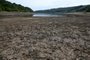 The dry, cracked bed of Scammonden Reservoir, revealed by the falling water level, is pictured west of Huddersfield, in northern England on July 17, 2022. - The UK's meteorological agency on Friday issued its first ever "red" warning for exceptional heat, forecasting record highs of 40 degrees Celsius next week. (Photo by Oli SCARFF / AFP)<!-- NICAID(15153434) -->