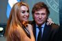 Argentine presidential candidate for the La Libertad Avanza alliance Javier Milei (R) celebrates with his girlfriend Fatima Florez after winning the presidential election runoff at his party headquarters in Buenos Aires on November 19, 2023. Libertarian outsider Javier Milei pulled off a massive upset Sunday with a resounding win in Argentina's presidential election, a stinging rebuke of the traditional parties that have overseen decades of economic decline. (Photo by LUIS ROBAYO / AFP)<!-- NICAID(15603490) -->