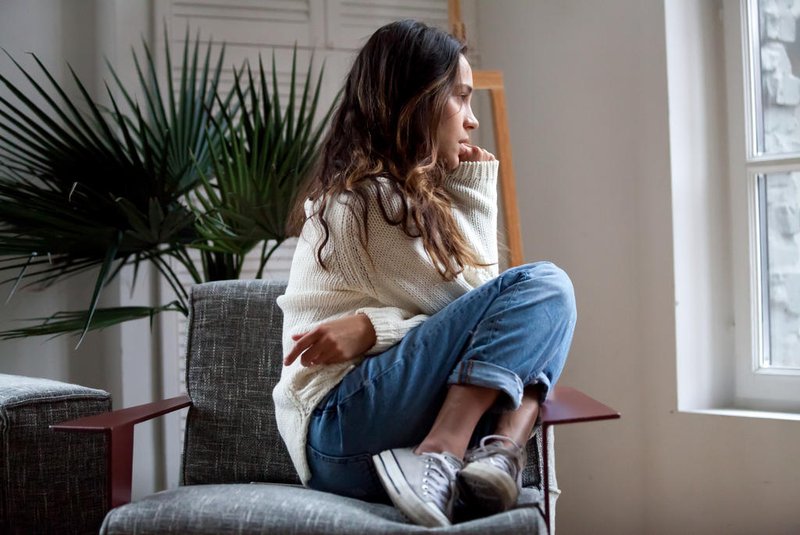 Sad thoughtful girl sitting on chair feeling depressed or lonelySad thoughtful teen girl sits on chair feels depressed, offended or lonely, upset young woman suffers from abuse, harassment or heartbreak, grieving lady or violence victim has psychological problemFonte: 200576229<!-- NICAID(15533330) -->