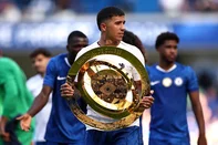 Chelsea's Argentinian midfielder #08 Enzo Fernandez carries the Club World Cup trophy following the pre-season friendly football match between Chelsea and AC Milan at Stamford Bridge in London on August 10, 2025. (Photo by HENRY NICHOLLS / AFP)<!-- NICAID(16101288) -->