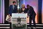 Argentina's Football Association (AFA) president Claudio Tapia (R), Conmebol's president Paraguayan Alejandro Dominguez (L), and Dominguez's mother, Peggy Wilson-Smith, take part in a tribute to Dominguez's father, Osvaldo Dominguez, during the Copa Libertadores and Copa Sudamericana draw at Conmebol's headquarters in Luque, Paraguay, on March 18, 2024. (Photo by NORBERTO DUARTE / AFP)<!-- NICAID(15709443) -->