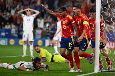 Spain's forward #19 Lamine Yamal (C) and Spain's forward #07 Alvaro Morata (centre right) celebrate as Italy's defender #05 Riccardo Calafiori (L) reacts after scoring an own goal during the UEFA Euro 2024 Group B football match between Spain and Italy at the Arena AufSchalke in Gelsenkirchen on June 20, 2024. (Photo by PATRICIA DE MELO MOREIRA / AFP)<!-- NICAID(15794200) -->