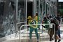 Supporters of Brazilian former President Jair Bolsonaro destroy a window of the the plenary of the Supreme Court in Brasilia on January 8, 2023. - Hundreds of supporters of Brazil's far-right ex-president Jair Bolsonaro broke through police barricades and stormed into Congress, the presidential palace and the Supreme Court Sunday, in a dramatic protest against President Luiz Inacio Lula da Silva's inauguration last week. (Photo by Ton MOLINA / AFP)<!-- NICAID(15316378) -->