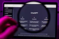 Chat GPT OpenAI through magnifying glass on screen <!-- NICAID(16054054) -->