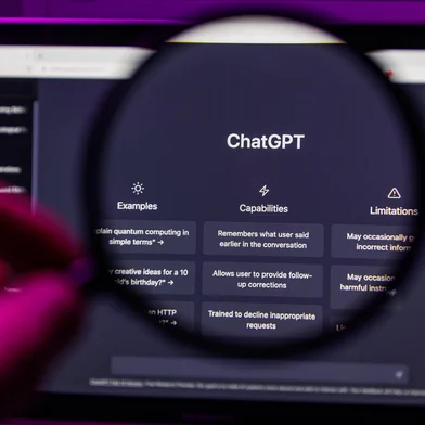 Chat GPT OpenAI through magnifying glass on screen <!-- NICAID(16054054) -->