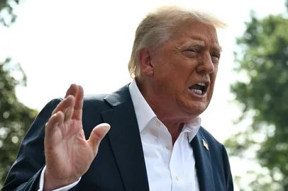 (FILES) US President Donald Trump speaks to the press before boarding Marine One on the South Lawn of the White House in Washington, DC, on July 11, 2025. President Donald Trump on July 12, 2025 said major US trading partners Mexico and the European Union would face a 30 percent tariff starting next month, ramping up pressure for deals in his trade wars. Both sets of duties would take effect August 1, Trump said in separate letters posted to his Truth Social platform, citing Mexico's role in illicit drugs flowing into the United States and a trade imbalance with the EU respectively. (Photo by ANDREW CABALLERO-REYNOLDS / AFP)<!-- NICAID(16079350) -->