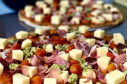 Sara Bodowsky Donna 25/02 O Artesão começou em Canoas em 2017, como uma loja que oferecia pizzas pré-assadas com coberturas deliciosas para finalizar em casa. Deu tão certo que começaram a receber encomendas de Porto Alegre e hoje, alguns anos depois, já têm uma loja na Capital.Eu já era fã dos produtos da Vane e do Léo lá no início, quando provei as pizzas e adorei a ideia de preparar os produtos frescos e diferenciados em casa. E sigo adorando a marca! O cardápio muda toda semana - todo ele ou em partes. Mas pode ter certeza - sempre há uma pizza diferente e deliciosa pra provar. A massa é fininha, de fermentação lenta e vem com dica para deixar as bordas crocantes. A salgada é feita com blend de farinhas brancas e integrais, já a doce tem um toque de cacau e baunilha.Hoje, além das pizzas salgadas e doces para assar em casa, a loja também oferece três blends de cafés especiais, geleias, doce de leite artesanal feito com fava de baunilha e vinhos e espumantes das vinícolas gaúchas Casa Valduga e Luiz Argenta.Em Porto Alegre, a loja fica na Rua Carvalho Monteiro, 230, bairro Petrópolis, e funciona de terça a sábado, das 15h às 21h30, com entrega na capital e na Região Metropolitana pelo WhatsApp (51) 99299-6260. Já em Canoas o endereço é na Av. Dr. Sezefredo Azambuja Vieira, 2246, com fone/WhatsApp (51) 99299-6260.<!-- NICAID(15356454) -->