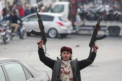 An anti-government fighter celebrates at Umayyad Square in Damascus on December 8, 2024. Celebrations erupted around Syria and crowds ransacked President Bashar al-Assad's luxurious home on December 8 after Islamist-led rebels swept into Damascus and declared he had fled the country, in a spectacular end to five decades of Baath party rule. (Photo by Bakr AL KASSEM / AFP)Editoria: WARLocal: DamascusIndexador: BAKR AL KASSEMSecao: conflict (general)Fonte: AFPFotógrafo: STR<!-- NICAID(15931099) -->