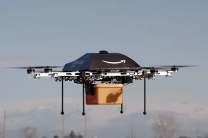 This undated handout photo released by Amazon on December 1, 2013 shows a flying "octocopter" mini-drone that would be used to fly small packages to consumers. Amazon CEO Jeff Bezos revealed on December 1 that his company was looking to the future with plans to use mini-drones to deliver small packages. AFP PHOTO / AMAZON  --- EDITORS NOTE --- RESTRICTED TO EDITORIAL USE - MANDATORY CREDIT "AFP PHOTO / AMAZON " - NO MARKETING NO ADVERTISING CAMPAIGNS - DISTRIBUTED AS A SERVICE TO CLIENTS<!-- NICAID(10017675) -->