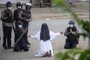 This handout photo taken on March 8, 2021 and released on March 9 by the Myitkyina News Journal shows a nun pleading with police not to harm protesters in Myitkyina in Myanmar's Kachin state, amid a crackdown on demonstrations against the military coup. (Photo by Handout / Myitkyina News Journal / AFP) / RESTRICTED TO EDITORIAL USE - MANDATORY CREDIT "AFP PHOTO / Myitkyina News Journal " - NO MARKETING - NO ADVERTISING CAMPAIGNS - DISTRIBUTED AS A SERVICE TO CLIENTS<!-- NICAID(14731672) -->