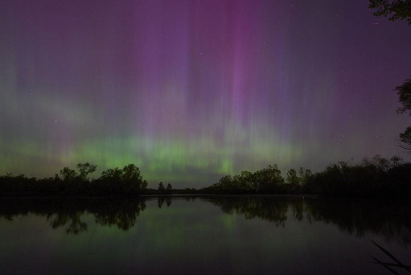 Northern lights or aurora borealis illuminate the night sky near London, Ontario, during a geomagnetic storm on May 10, 2024. The most powerful solar storm in more than two decades struck Earth on May10, 2024, triggering spectacular celestial light shows in skies from Tasmania to Britain -- and threatening possible disruptions to satellites and power grids as it persists into the weekend. Auroras are often observed in Canada's northern regions, but rarely in southern Ontario. (Photo by Geoff Robins / AFP)<!-- NICAID(15761503) -->