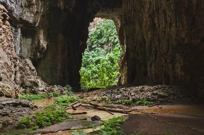 A cave entrance in the Peruaçu Caves National Park, home to a group of more than 250 caves with rock paintings dating back approximately 12,000 years, in the municipality of Itacarambi, Minas Gerais State, Brazil , on January 9, 2025. The United Nations Educational, Scientific and Cultural Organization (UNESCO) declared the Peruacu Caves National Park a World Natural Heritage Site on July 13, 2025 during a session of the World Heritage Committee in Paris. (Photo by Evandro Pereira / AFP)<!-- NICAID(16080088) -->