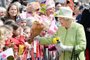 Britain's Queen Elizabeth II greets wellwishers during a 'walkabout' on her 90th birthday in Windsor, west of London, on April 21, 2016. Britain celebrates Queen Elizabeth II's 90th birthday on Thursday, with her eldest son Prince Charles paying tribute in a special radio broadcast and Prime Minister David Cameron leading a parliamentary homage.John Stillwell / POOL / AFPEditoria: HUMLocal: WindsorIndexador: JOHN STILLWELLSecao: imperial and royal mattersFonte: POOLFotógrafo: STF<!-- NICAID(12151507) -->