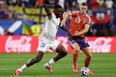 Haiti's forward #20 Frantzdy Pierrot and Scotland's midfielder #19 Lewis Ferguson fight for the ball during the 2026 World Cup Group C football match between Haiti and Scotland at the Boston Stadium in Foxborough on June 13, 2026. (Photo by FRANCK FIFE / AFP)<!-- NICAID(16305917) -->